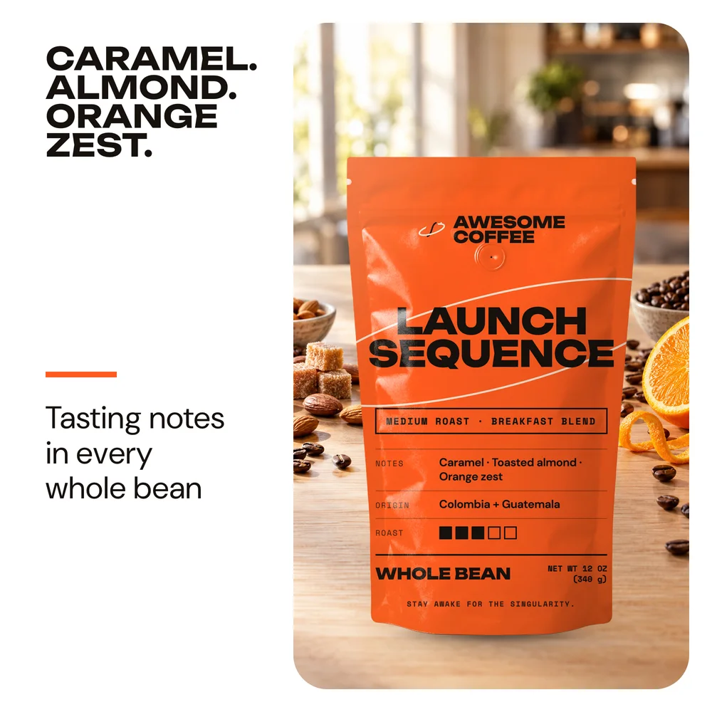 The Launch Sequence bag on a sunny kitchen counter with oranges and beans, headline Caramel. Almond. Orange zest.